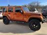 2011 Orange /Black Jeep Wrangler Unlimited Sahara 4WD (1J4BA5H12BL) with an 3.8L V6 OHV 12V engine, Auto transmission, located at 204 Hwy. 16 East, Carthage, MS, 39051, (601) 267-7277, 0.000000, 0.000000 - Photo#1