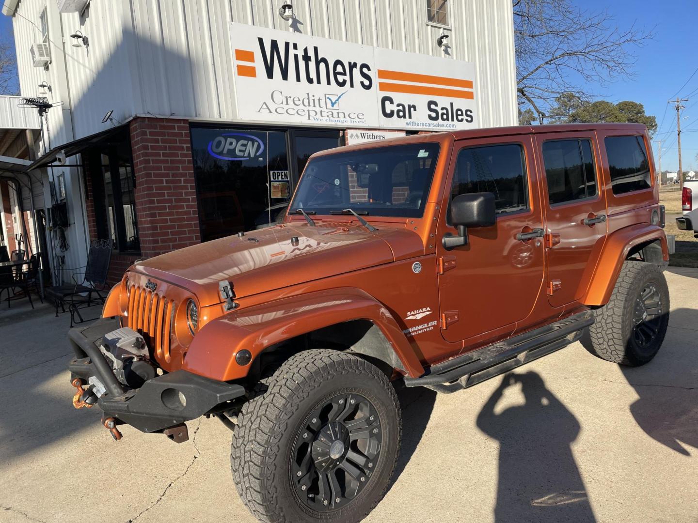 2011 Orange /Black Jeep Wrangler Unlimited Sahara 4WD (1J4BA5H12BL) with an 3.8L V6 OHV 12V engine, Auto transmission, located at 204 Hwy. 16 East, Carthage, MS, 39051, (601) 267-7277, 0.000000, 0.000000 - Photo#0